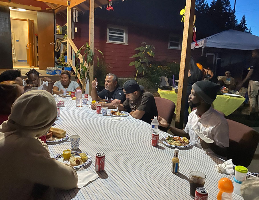 People eating outside at our community dinner.